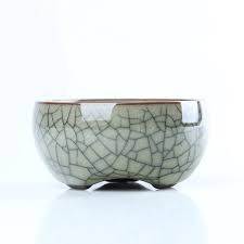 A small ceramic bowl with crackled glaze on a white background.