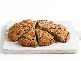 A round tray of four sliced scones with a golden-brown crust.