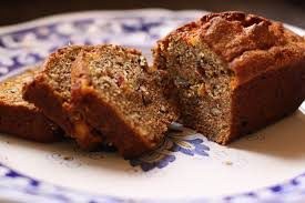 Sliced nut bread on a decorative plate.