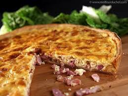 Close-up of a savory quiche with ham and cheese.