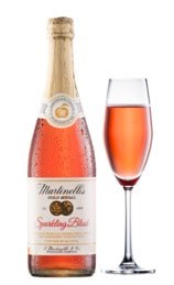 A bottle of sparkling rosé wine with a filled flute glass.