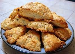 A plate of freshly baked scones with a golden crust.