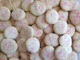 Close-up of white cookies with pink sprinkles.