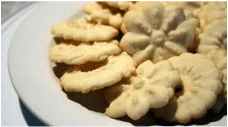 Plate of decorative butter cookies with floral patterns.