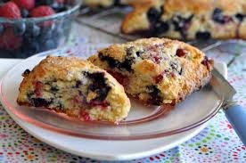 Close-up of blueberry and cranberry scones on a plate.