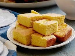 Plate of golden cornbread squares.