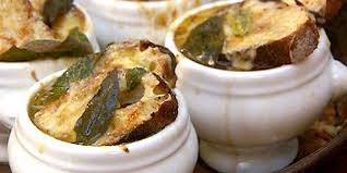 Close-up of baked stuffed eggplants in white ramekins.