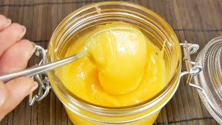 A spoon scooping golden honey from a jar.