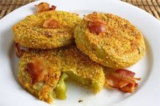 Crispy golden fried snacks with bacon pieces on top.