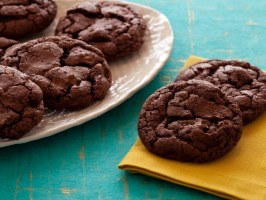 Delicious chocolate cookies on a rustic blue surface.