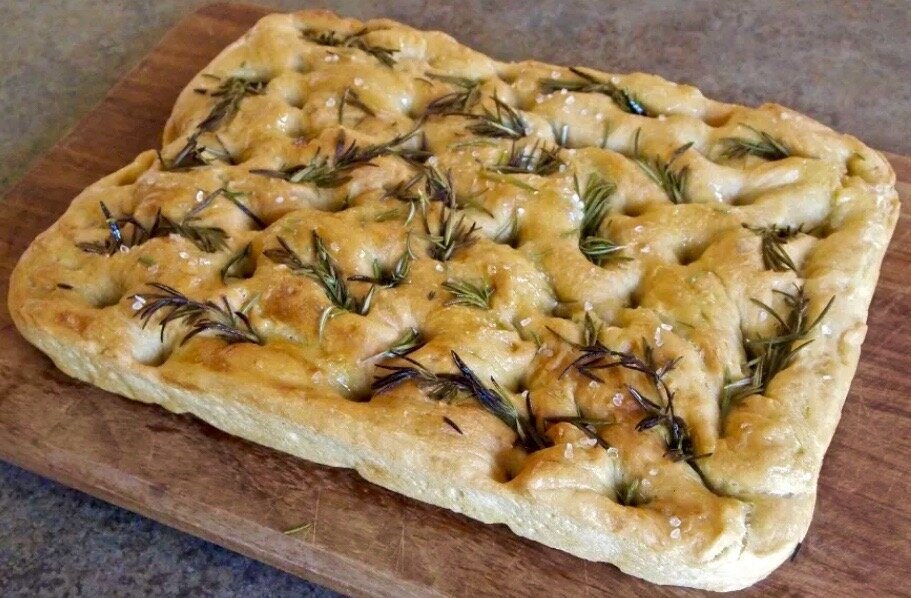 Freshly baked focaccia bread with rosemary on top.