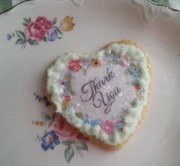 Heart-shaped cookie with 'Thank You' icing decoration.