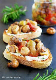 Toasted bread topped with mushrooms, nuts, and herbs.