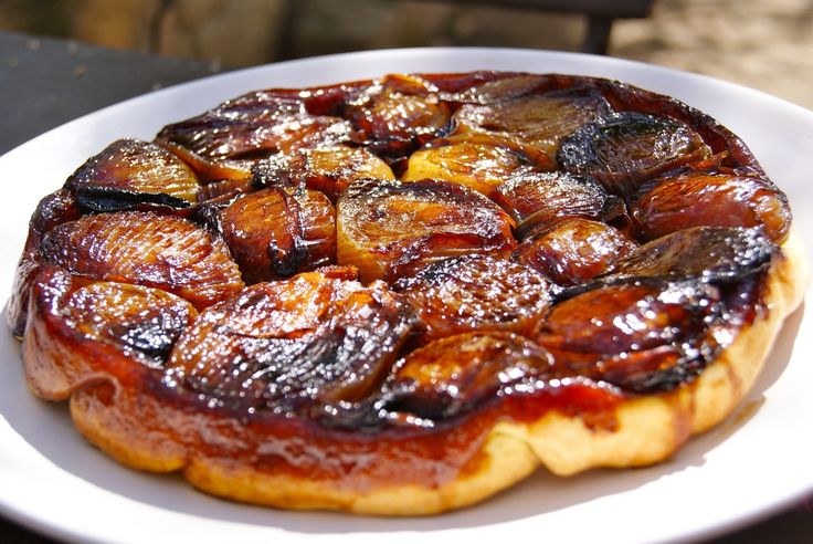 A caramelized plum tart with a golden crust.
