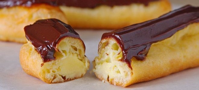 Close-up of chocolate eclairs with creamy filling.