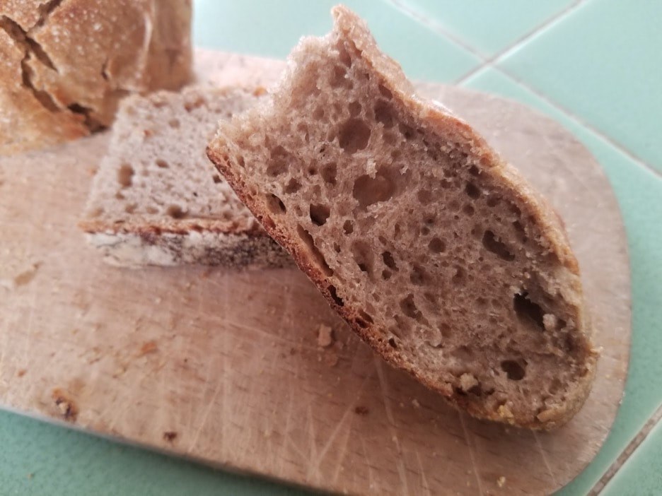 Close-up of freshly baked bread slices on a wooden board.