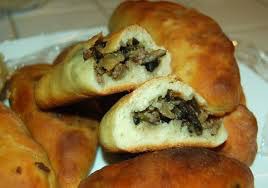 Close-up of baked pastries filled with a mushroom mixture.