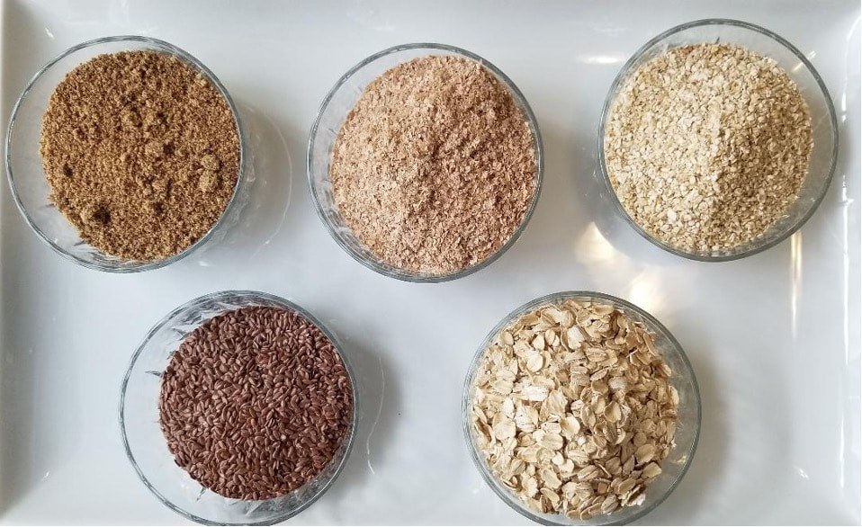 Various bowls filled with different types of grains and oats.