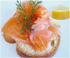 Smoked salmon on a toasted bagel with dill and lemon.