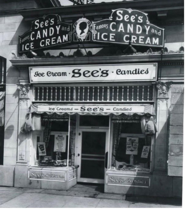 Historic black-and-white photo of See's Candy and Ice Cream shop storefront.