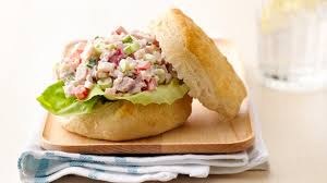 A fresh chicken salad sandwich on a biscuit.