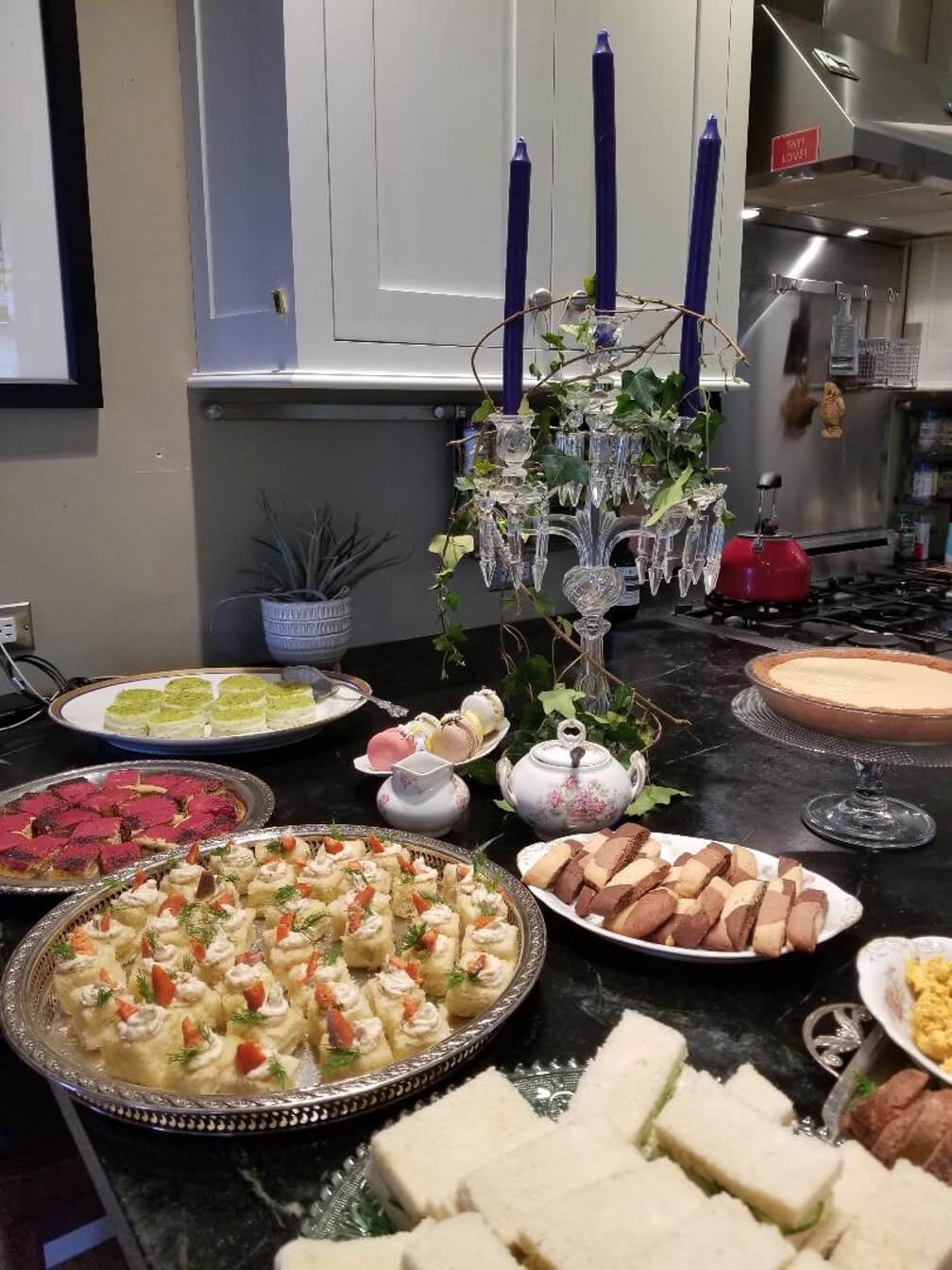 A table set with various dishes and a decorative candelabra centerpiece.