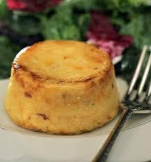 A creamy flan dessert with caramelized top on a plate.