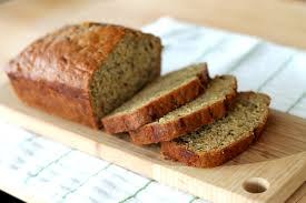 Sliced loaf of homemade bread on a wooden cutting board.