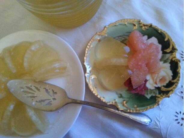 A vintage plate with lemon slices and a decorative fork on a cloth.