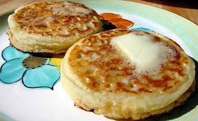 Two golden brown pancakes with butter on top.