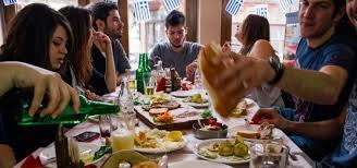 Friends enjoying a lively meal together at a festive table.