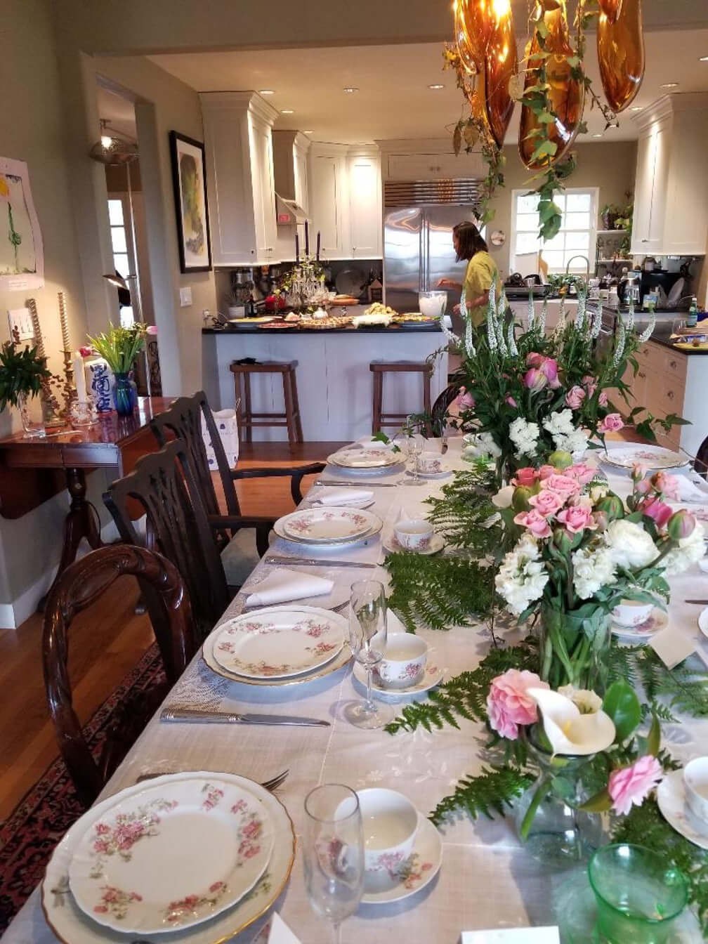 Elegantly set dining table with floral centerpiece in a cozy home.