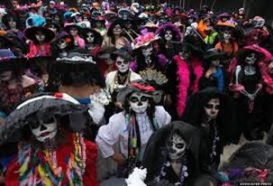 A crowd dressed as skeletons in colorful costumes during a festive event.