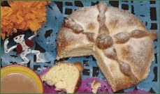 Traditional sweet bread with a slice cut out, placed on colorful paper.