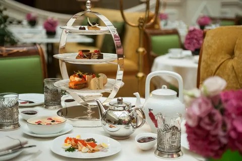 Elegant afternoon tea setup with tiered trays and fine china.