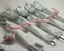 Set of vintage silverware tied with pink ribbons.
