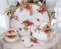Elegant floral porcelain tea set with tray, teapot, cups, and saucers.