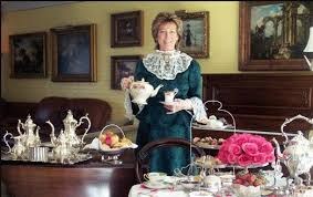 Elegant woman with a cat in a vintage tea room.