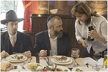 Man and woman dining together at a formal event.