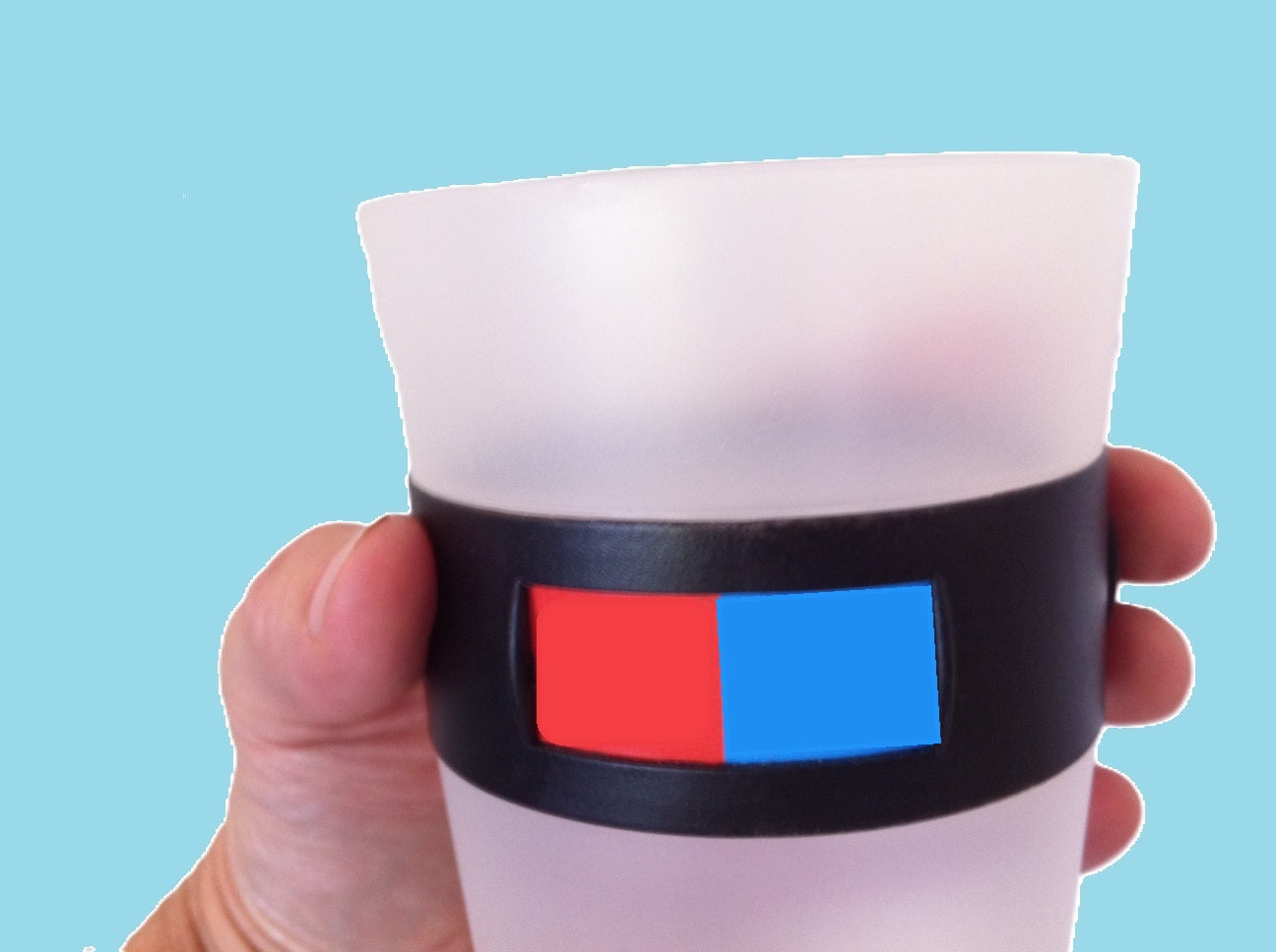 A hand holding a MyColourCup with its rotating color band
