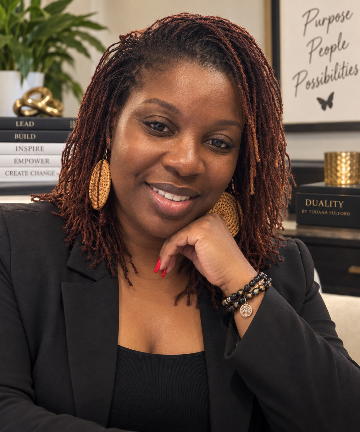 Tijuana Fulford smiling in a black blazer, with her hand resting beneath her chin