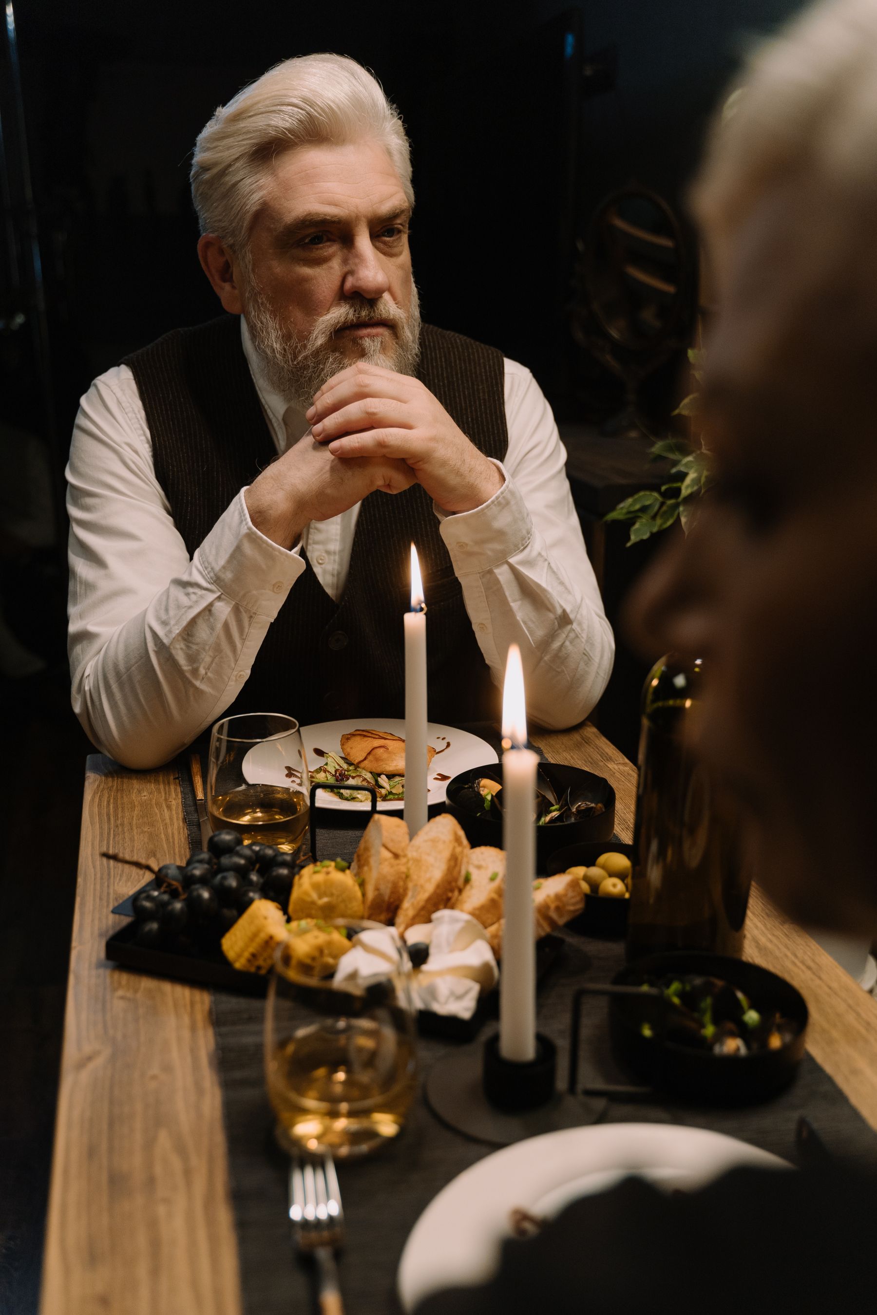 Couple sharing a candlelit dinner at home