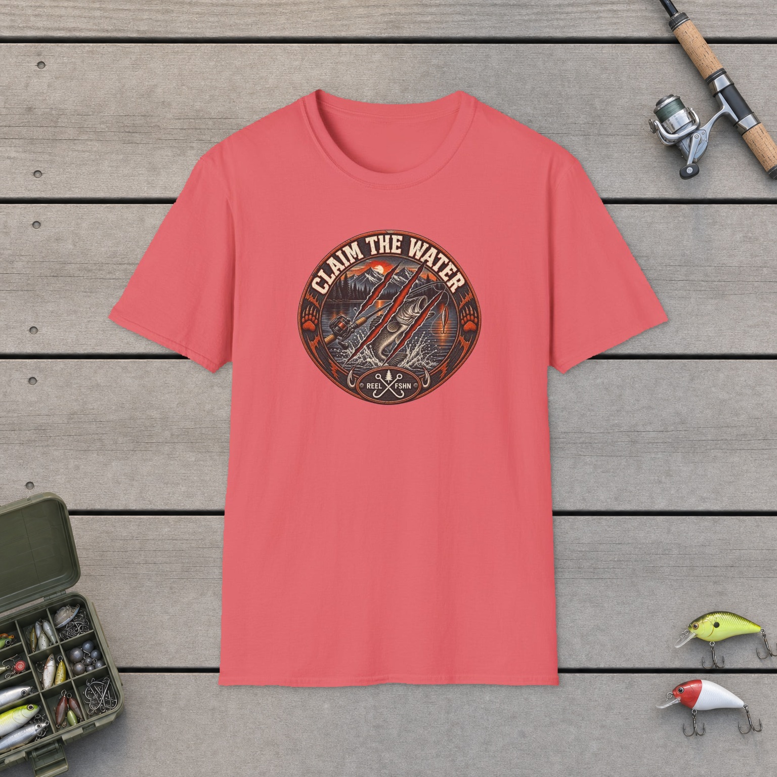 Claim The Water T-Shirt on a wooden dock with a fishing rod, reel, tackle box, and two lures