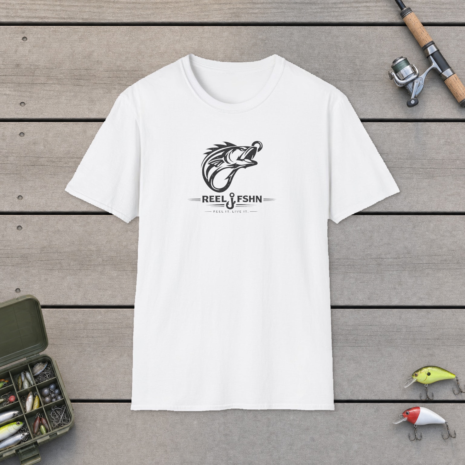 Fish Hook Monogram T-Shirt on a wooden dock with a fishing rod, reel, tackle box, and two lures
