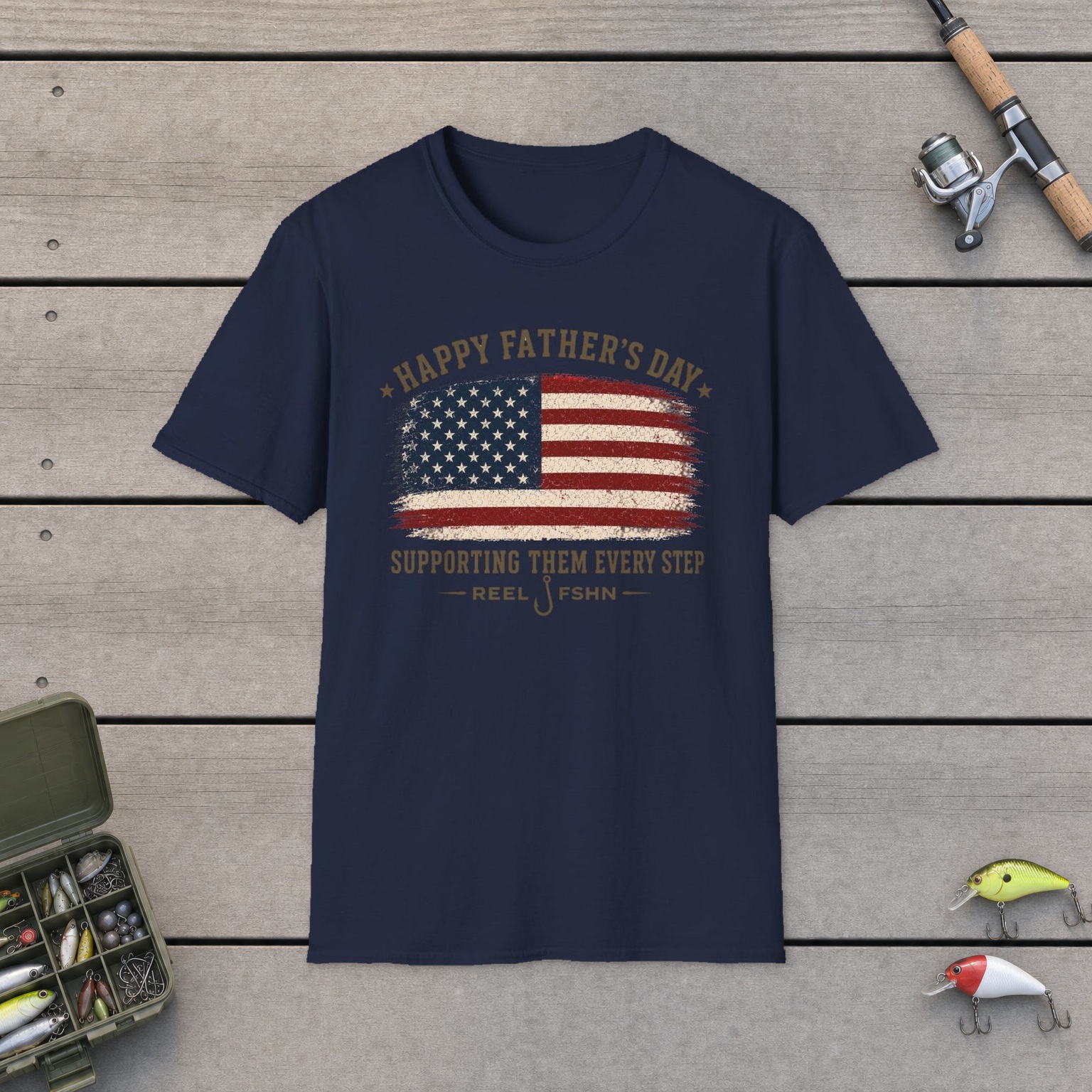 Happy Father's Day Supporting Them Every Step T-Shirt on a wooden dock with a fishing rod, reel, tackle box, and two lures