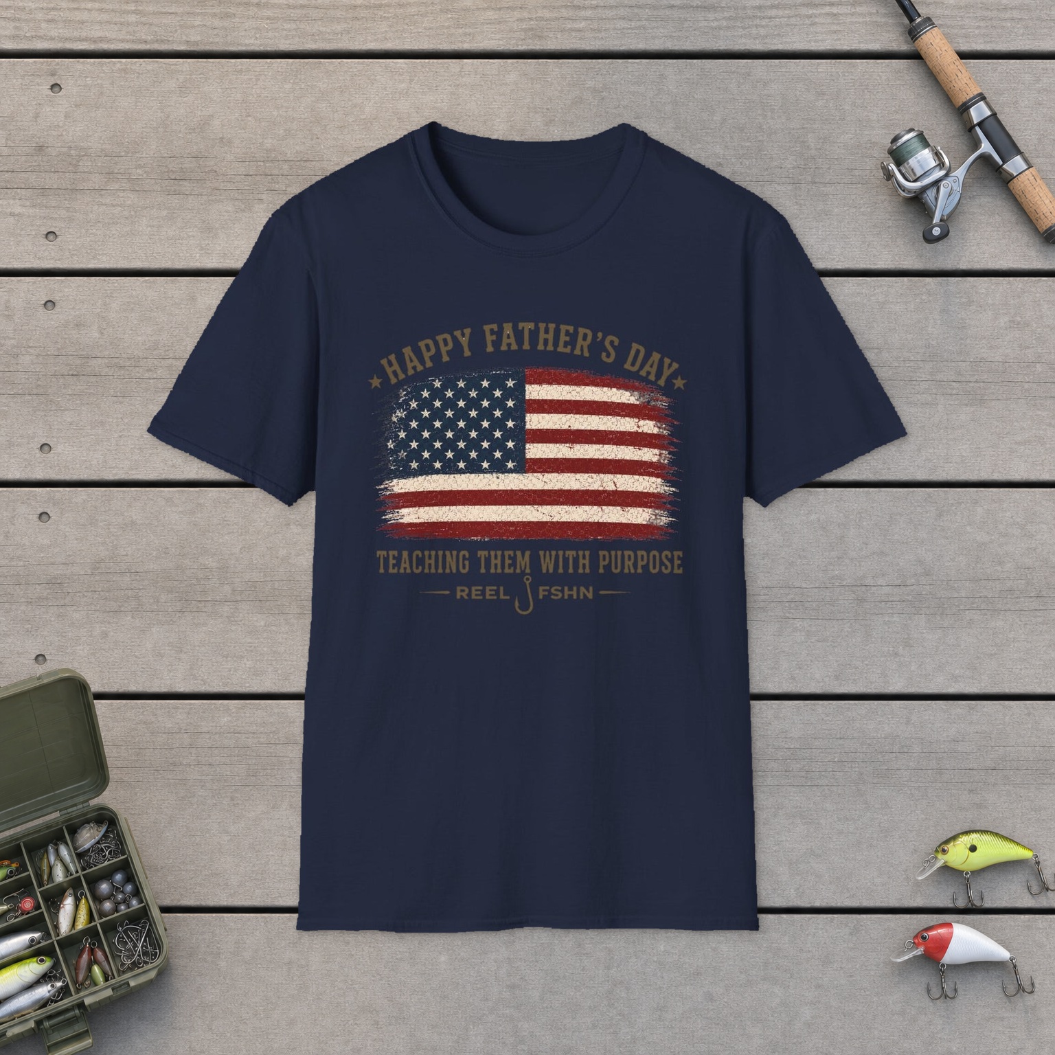 Happy Father's Day Teaching Them With Purpose T-Shirt on a wooden dock with a fishing rod, reel, tackle box, and two lures