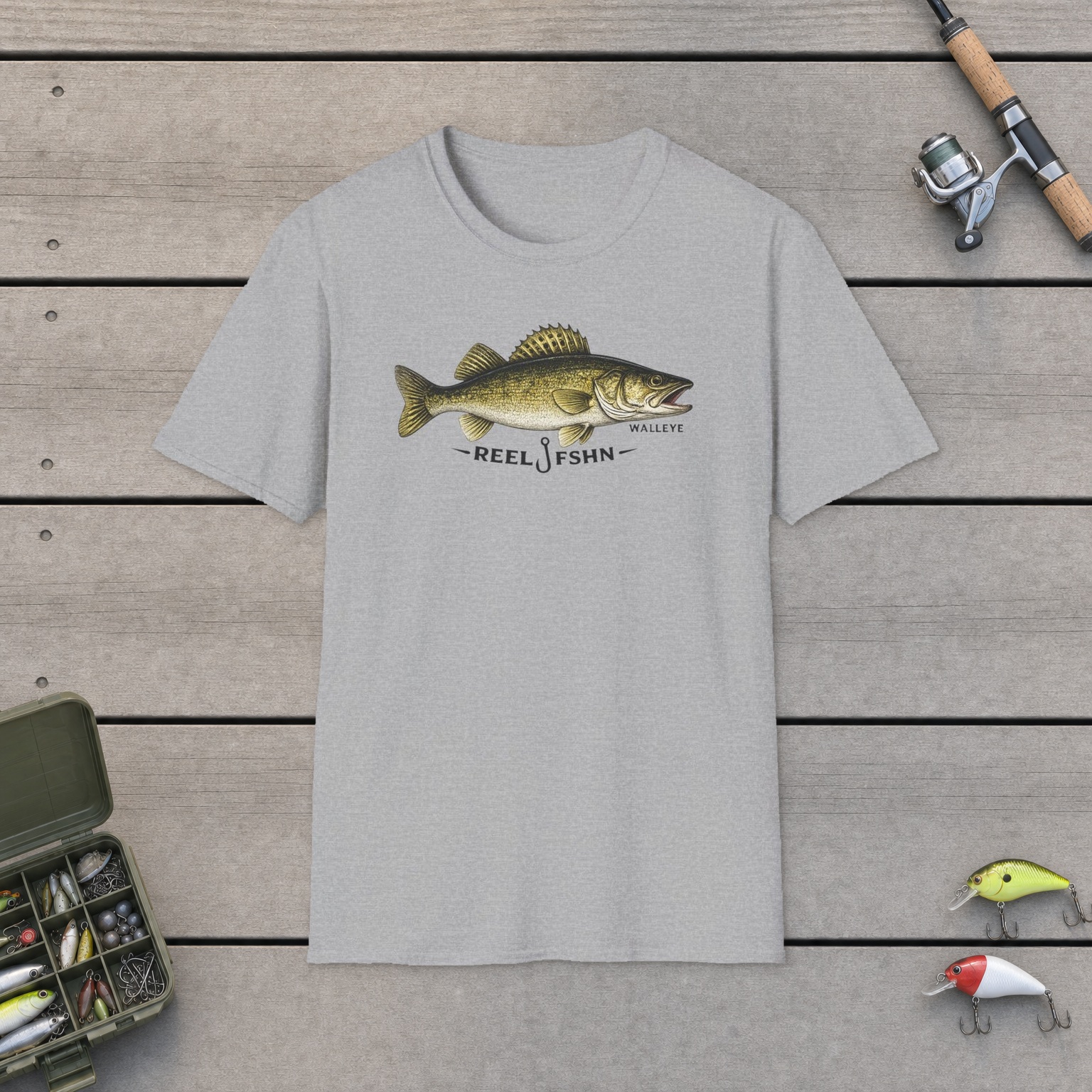 REEL FSHN WALLEYE T-Shirt on a wooden dock with a fishing rod, reel, tackle box, and two lures
