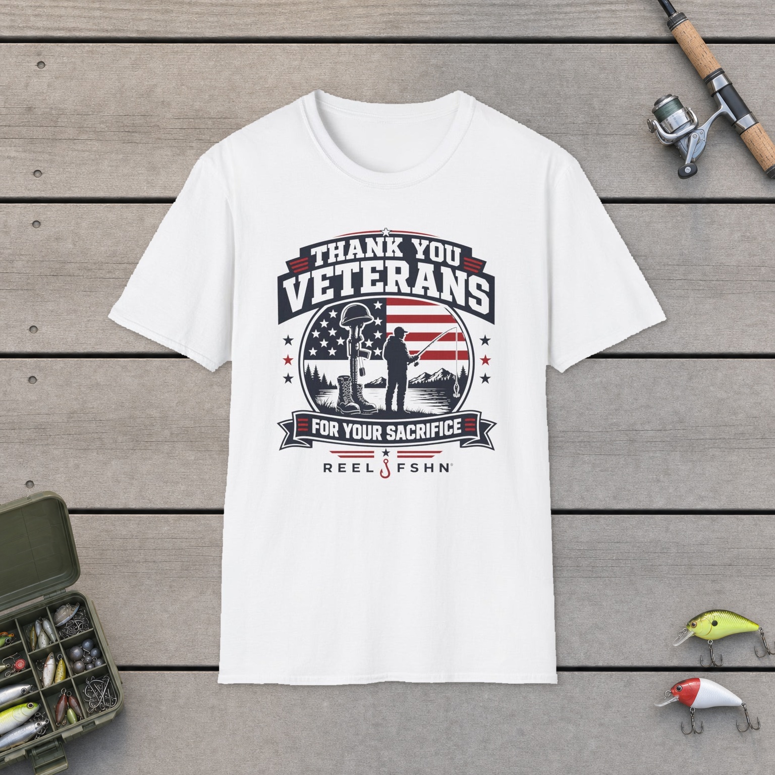 Thank You Veterans For Your Sacrifice T-Shirt on a wooden dock with a fishing rod, reel, tackle box, and two lures