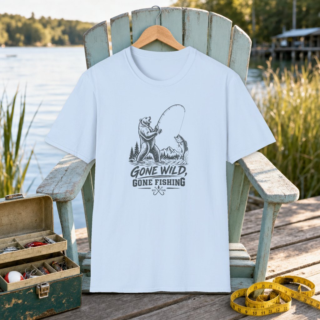 Gone Wild, Gone Fishing T-Shirt on a hanger on a seafoam fishing chair beside a lake, tackle box, and measuring tape