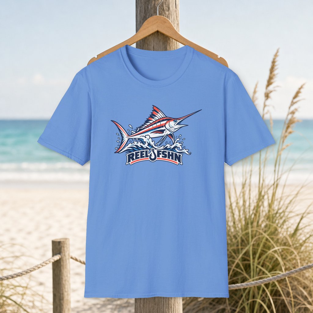 Leaping Marlin T-Shirt on a hanger beside a sandy beach and turquoise coastal water
